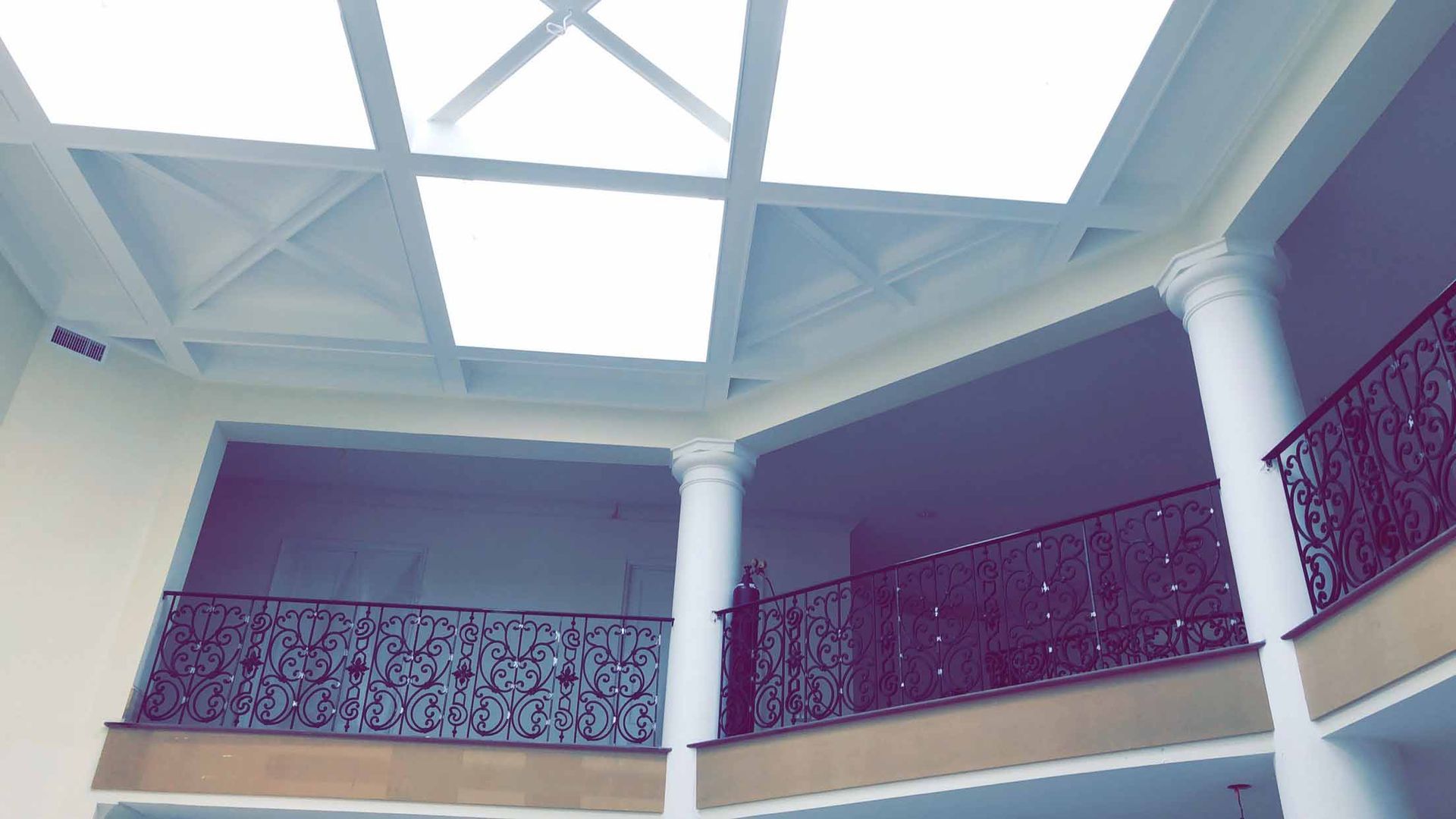 A building with a balcony and a ceiling fan