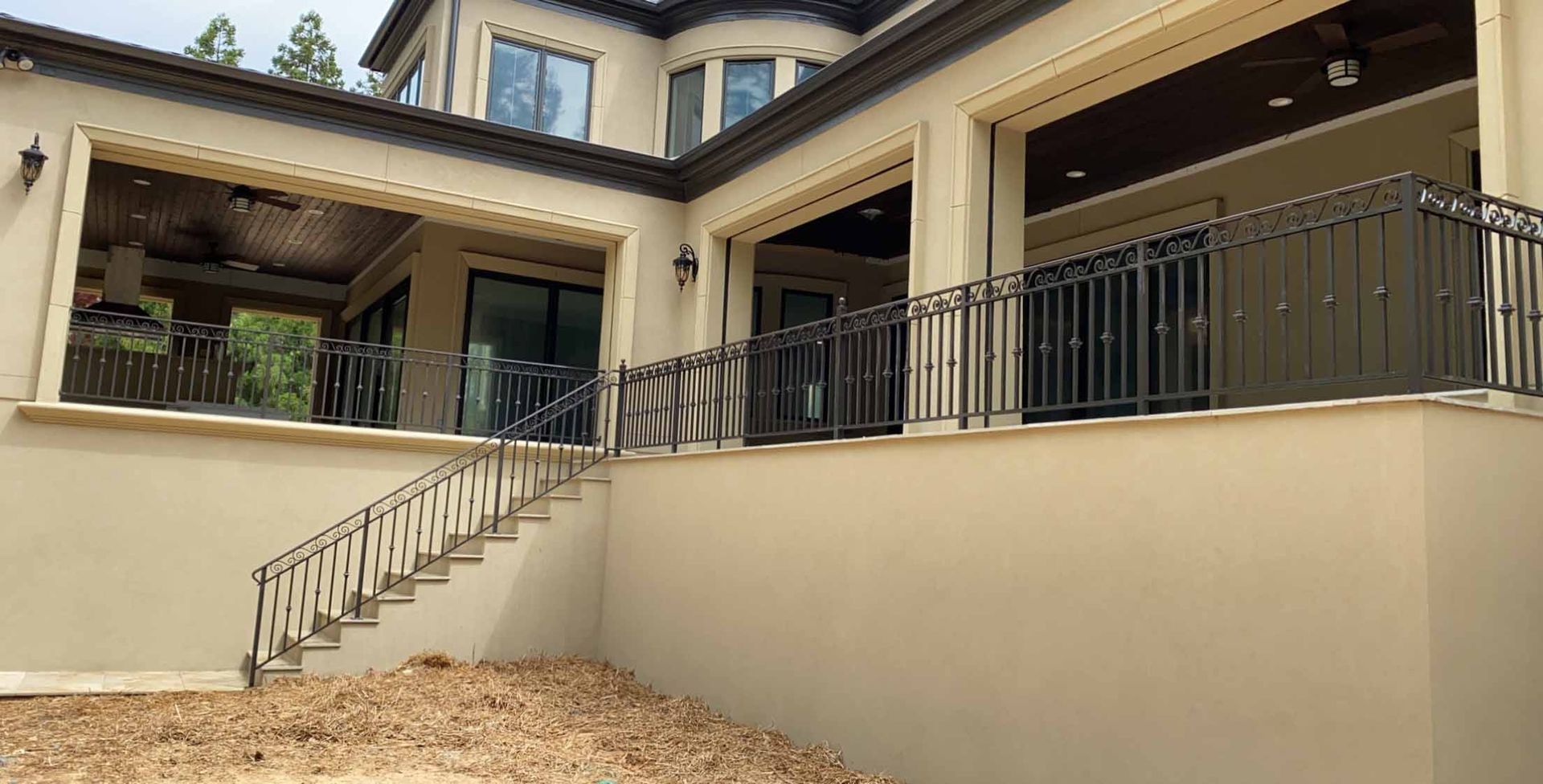 A large house with a balcony and stairs leading up to it.