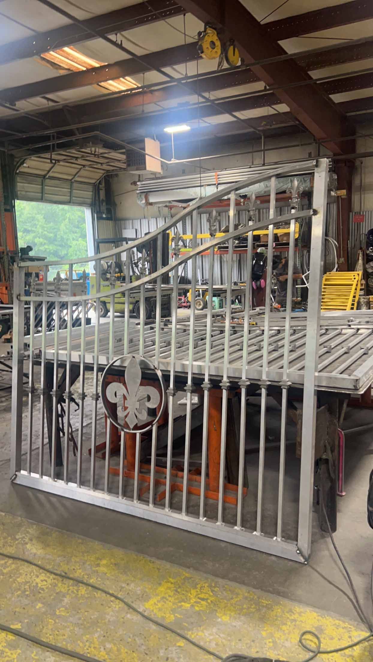 A metal fence is being built in a factory.