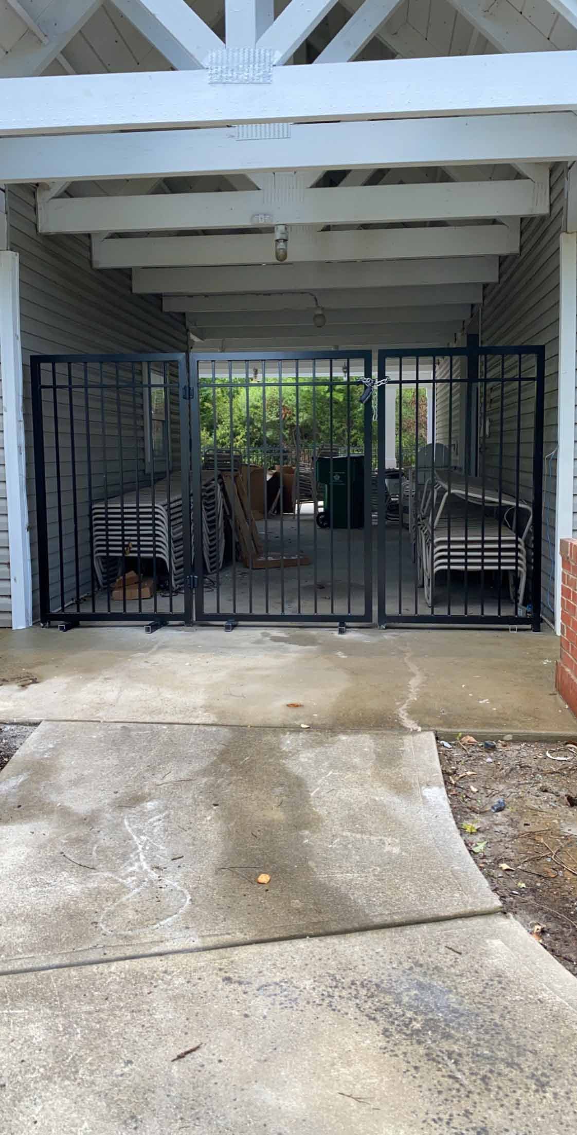 There is a gate in the middle of a garage.