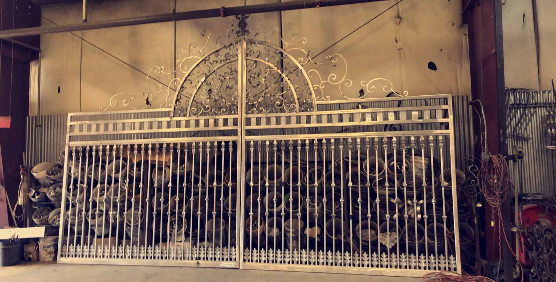 A large metal gate is sitting in a warehouse.