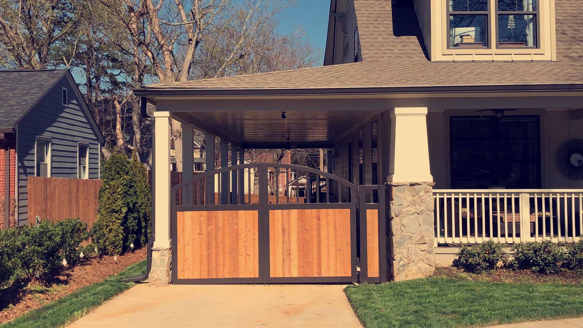A house with a wooden gate in front of it.