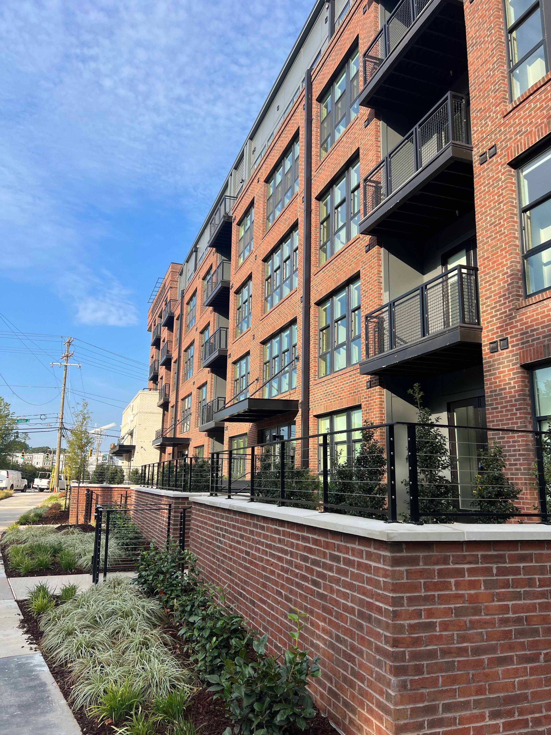 A large brick building with a lot of windows and balconies.