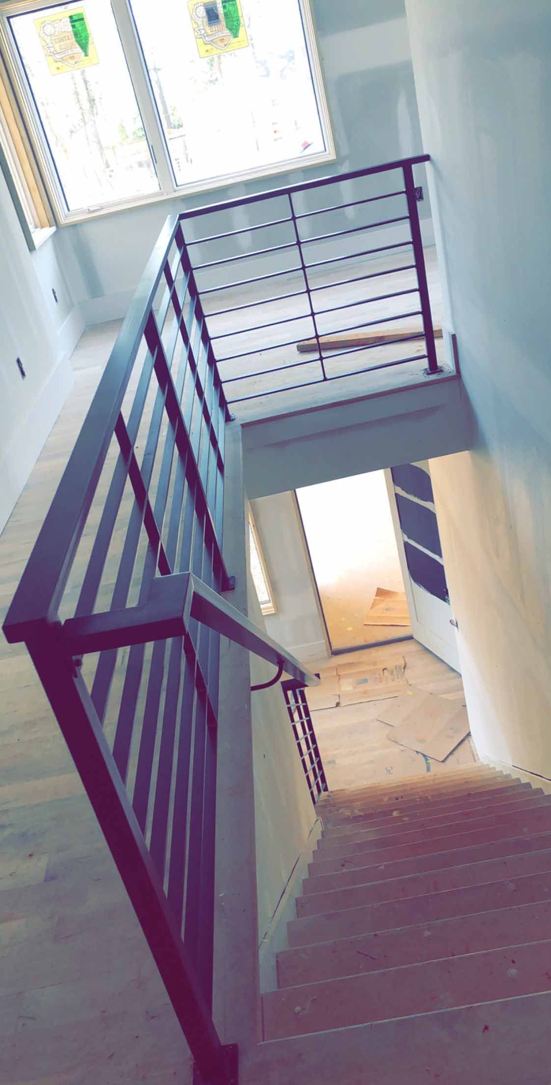 A picture of a staircase in a house under construction.
