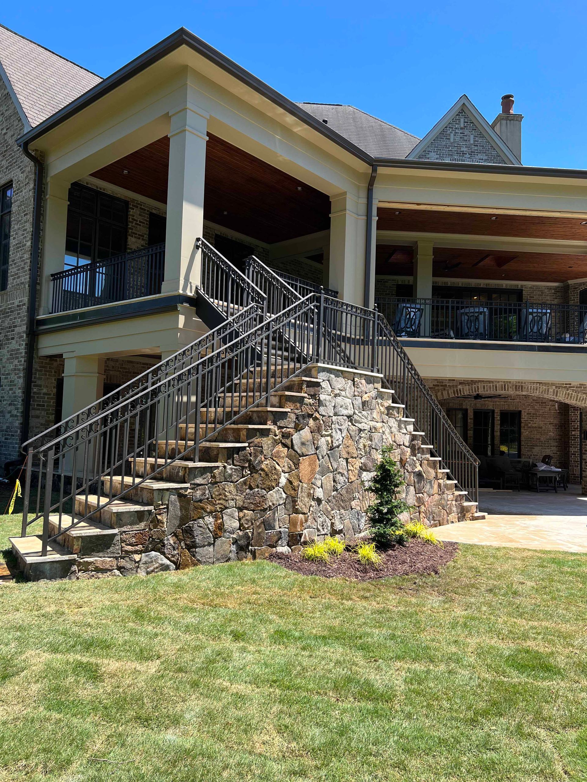 A large house with stairs leading up to the second floor.