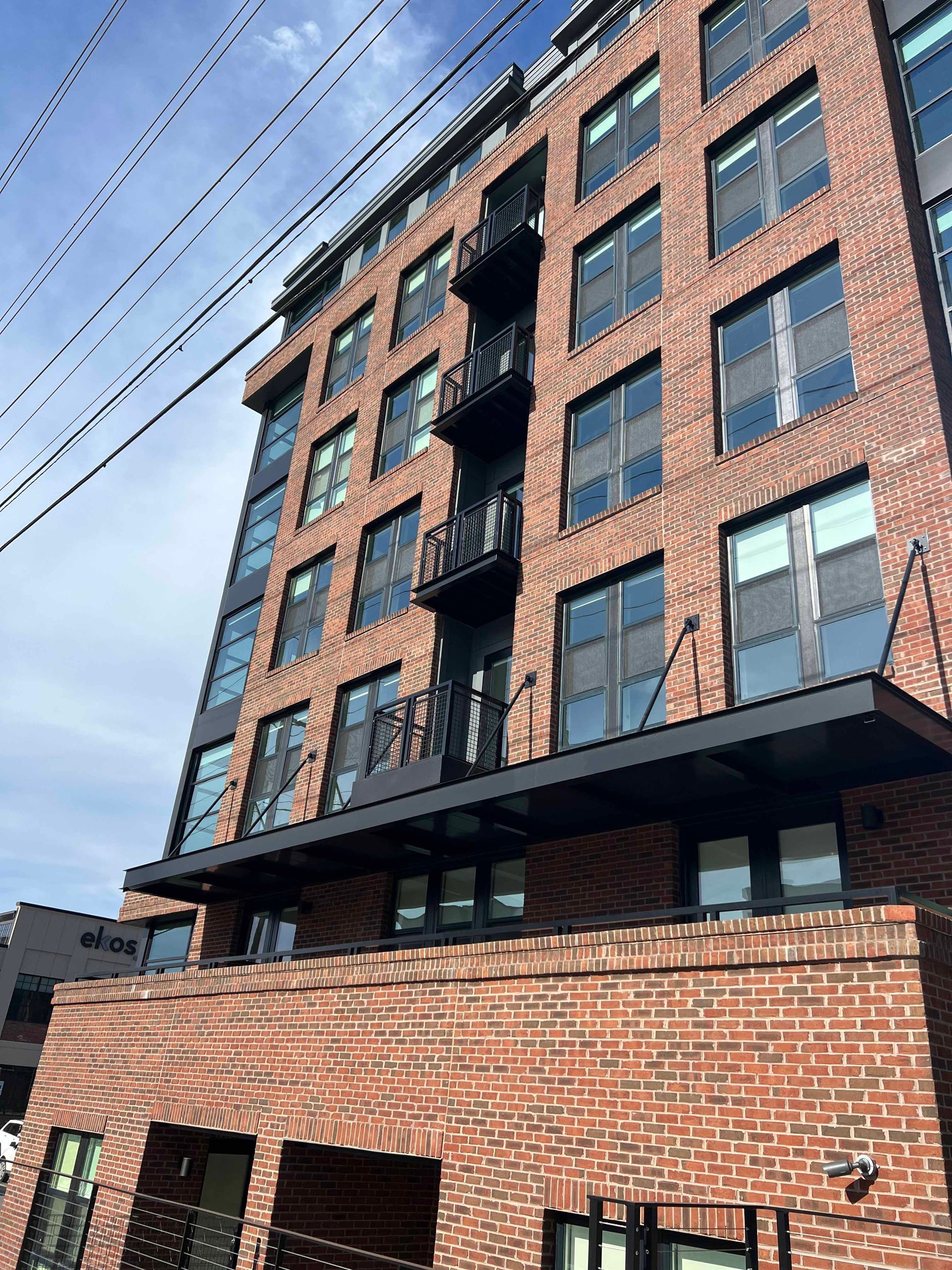 A large brick building with a fire escape on the top of it