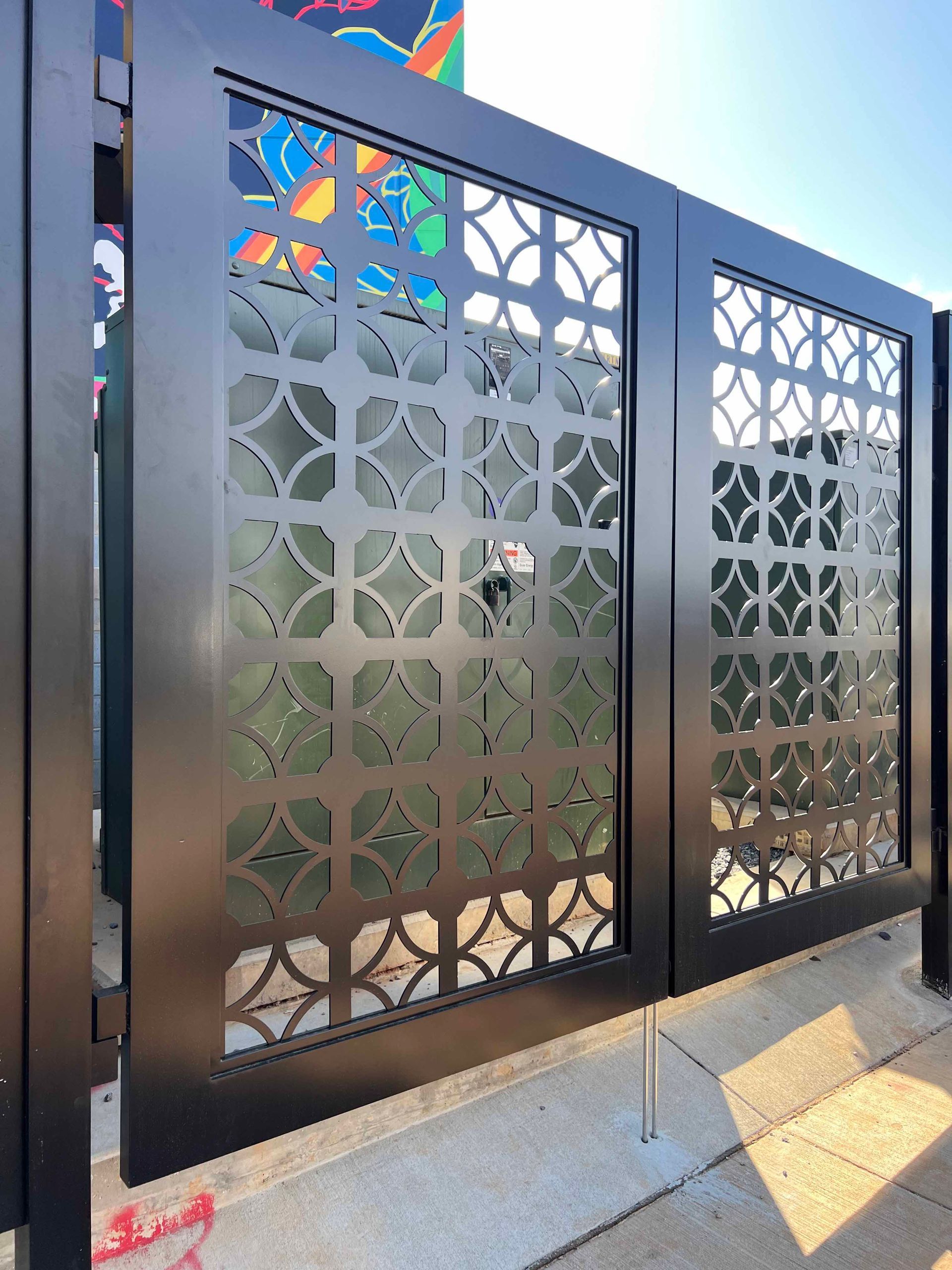 A black metal gate with a pattern on it