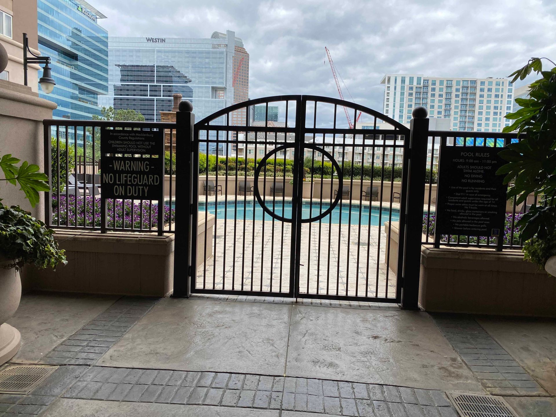 A wrought iron gate leading to a swimming pool