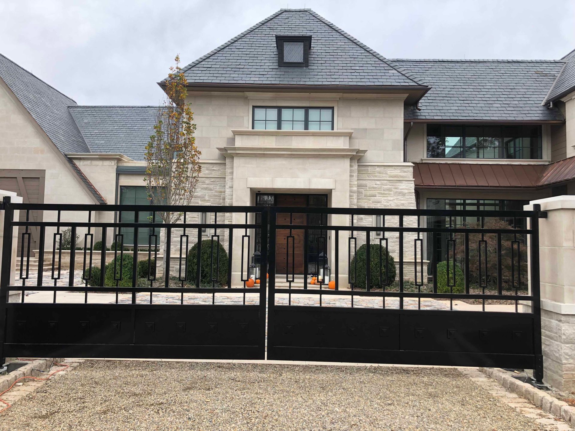 A large house with a black gate in front of it.