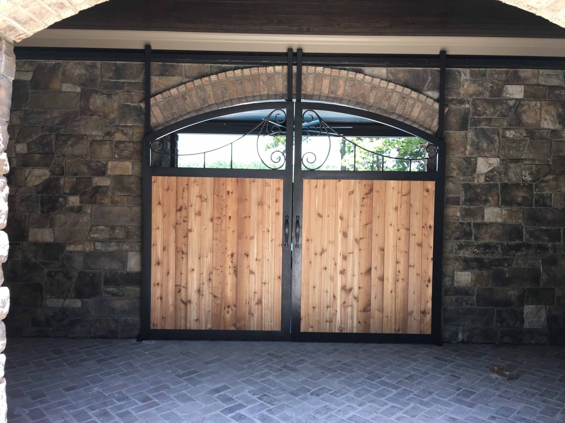 A brick wall with a wooden door in front of it
