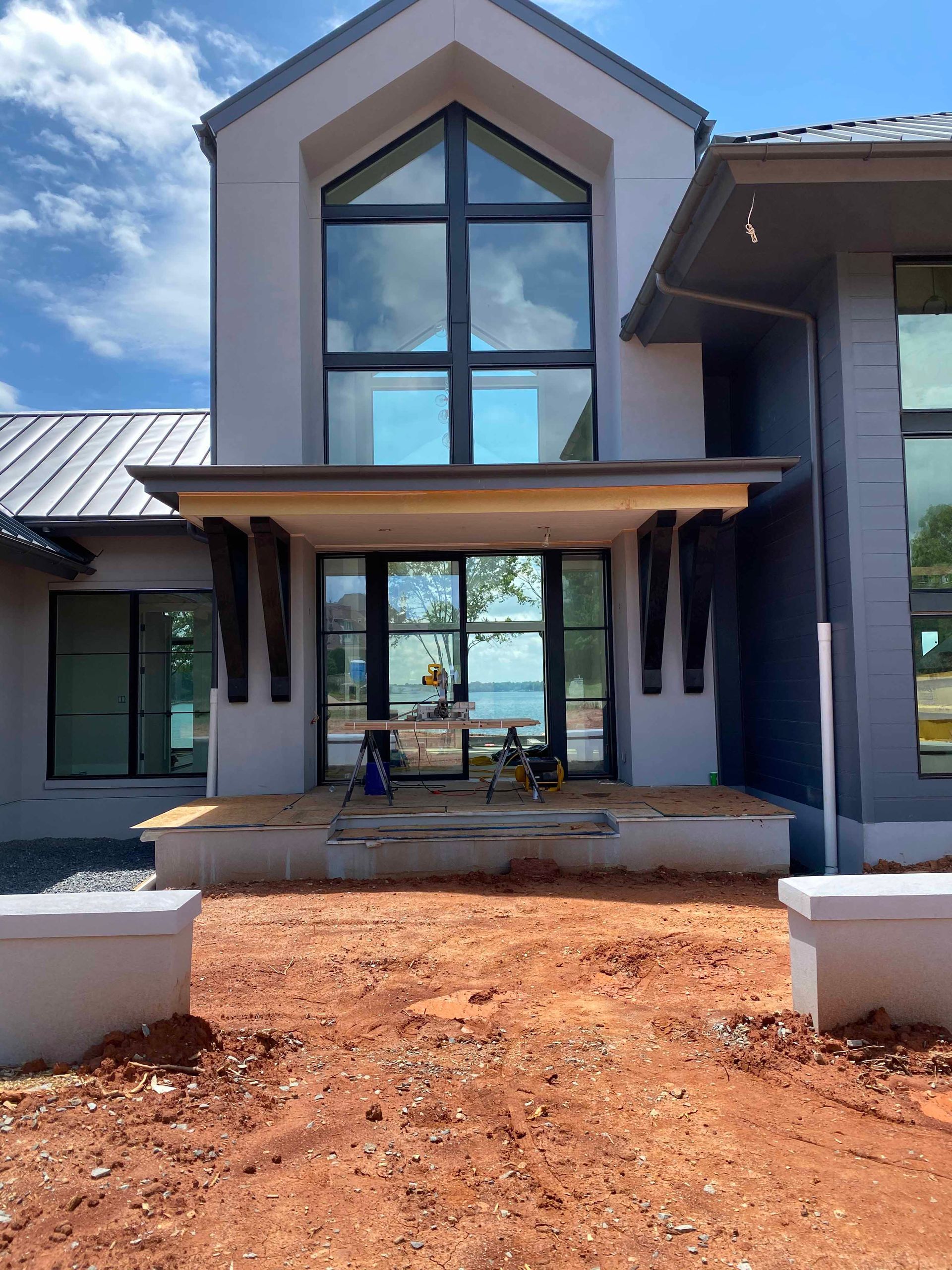A large house with a lot of windows is being built.