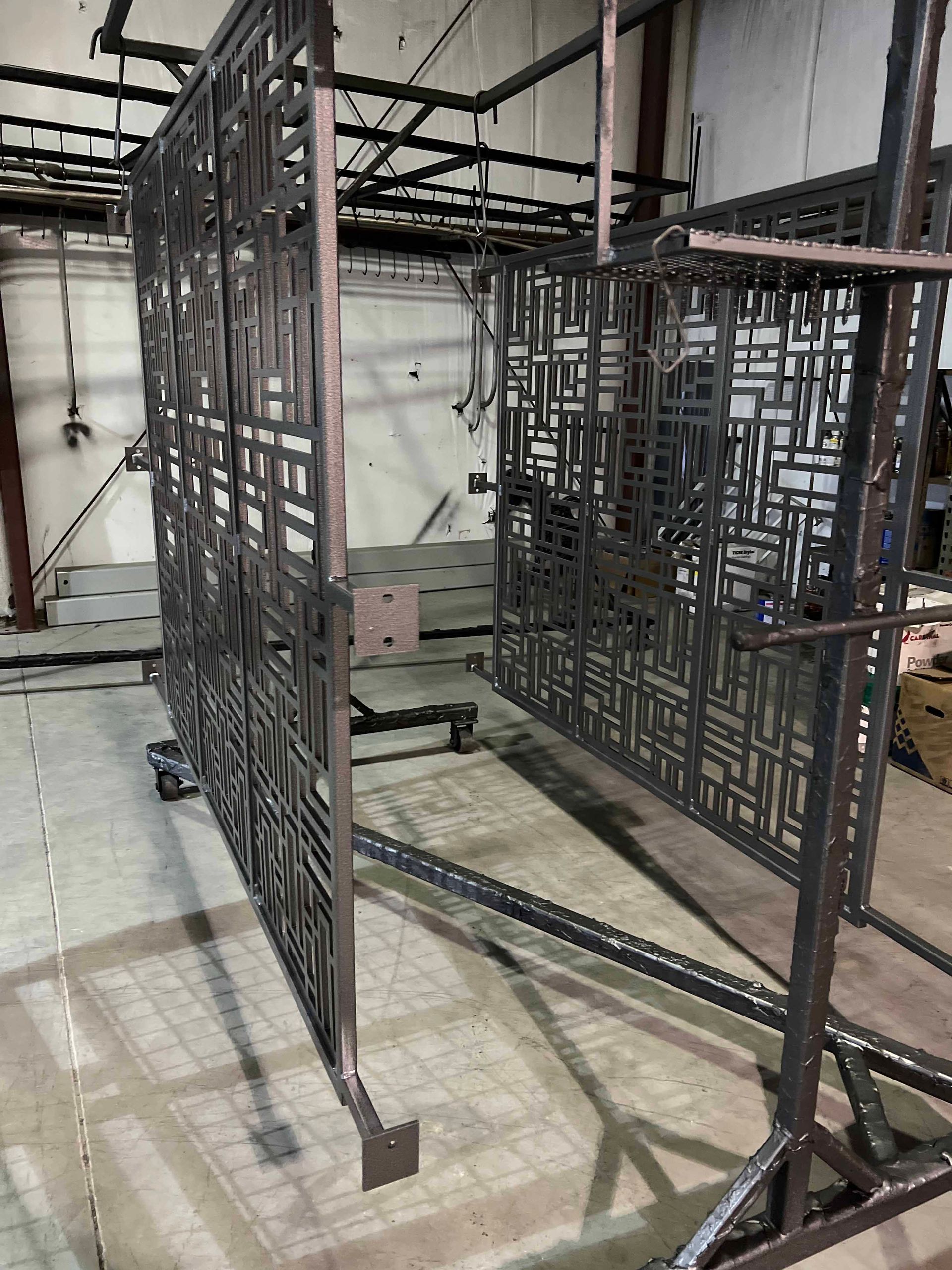 A large metal structure is sitting on the floor in a room.