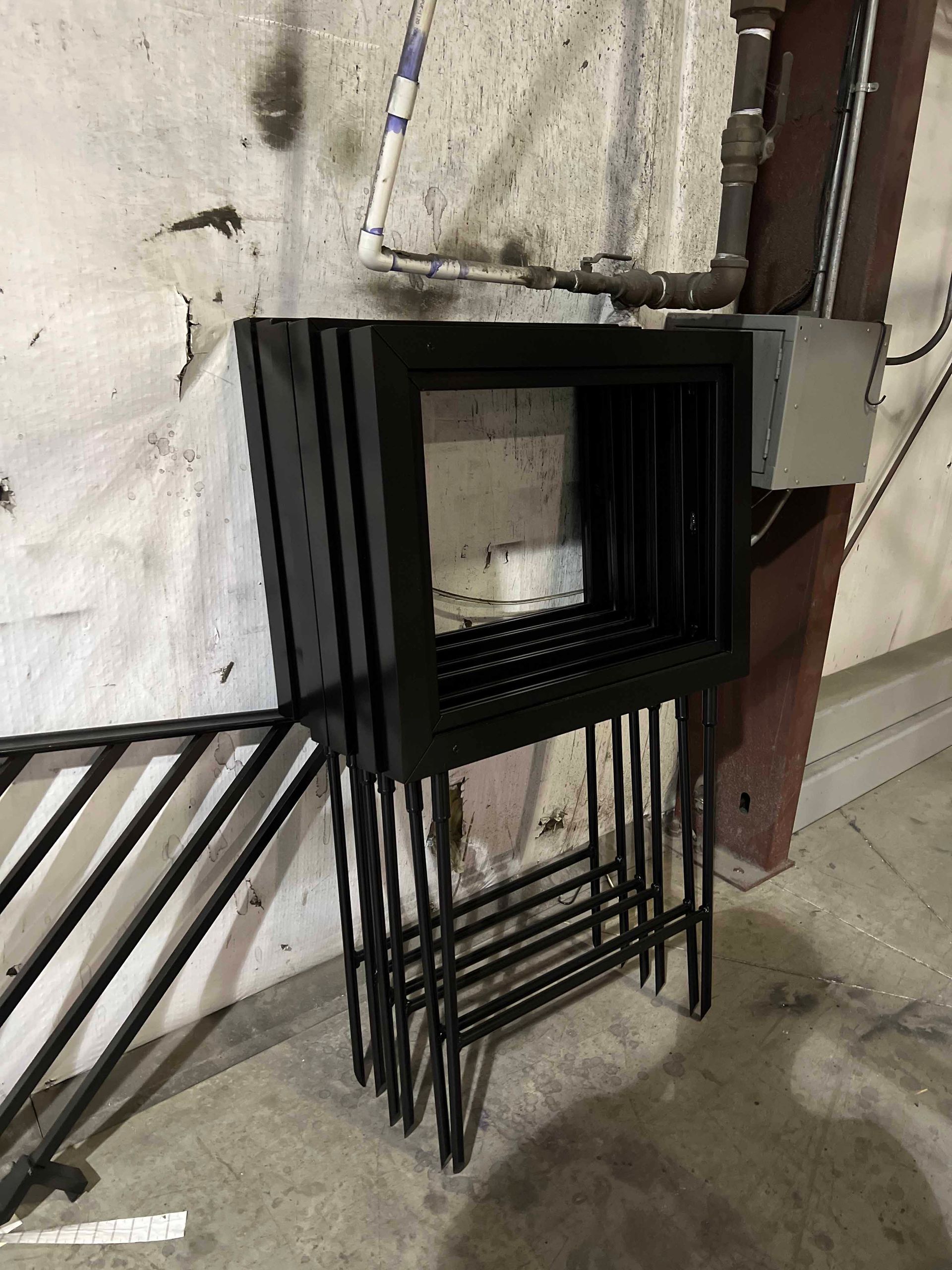 A stack of metal frames sitting on top of each other in a room.