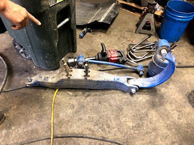 A person is pointing at a piece of metal on the floor.