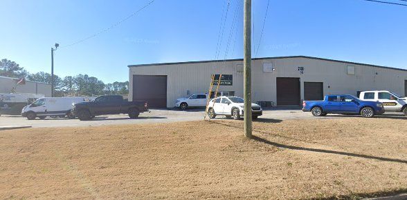 A row of trucks are parked in front of a building.