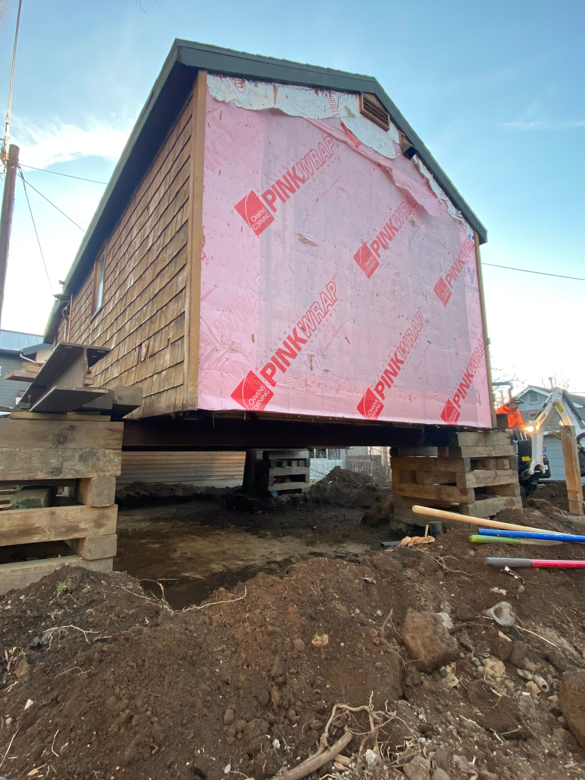 A house is being built on top of a pile of dirt.