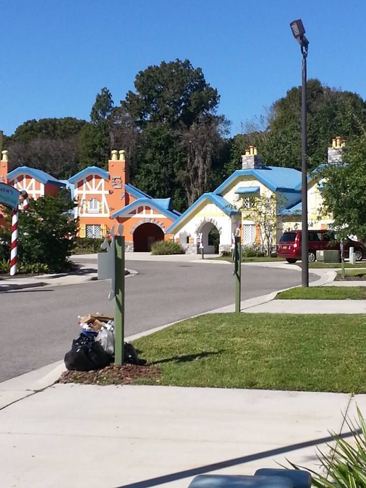 Colorful houses with blue and orange roofs on a sunny day.