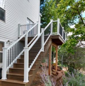 A house with a deck and stairs leading up to it