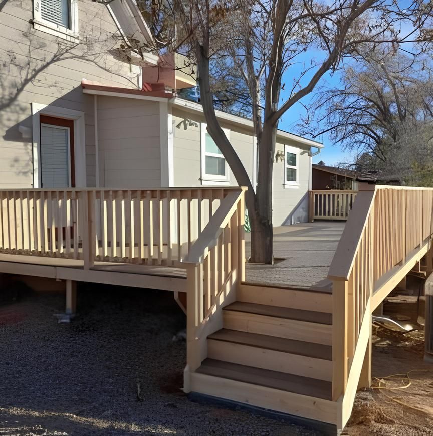 A house with a wooden deck and stairs leading up to it