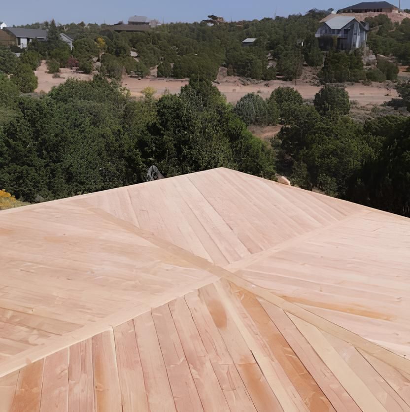 A wooden deck with trees in the background