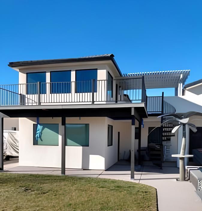 A white house with a balcony on top of it