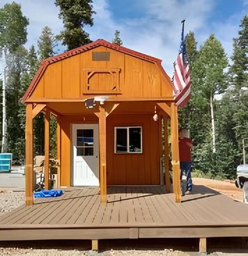 A small house with a porch and an American flag