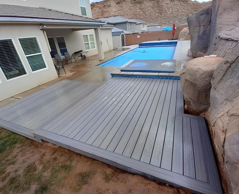 A large deck with a swimming pool in the background