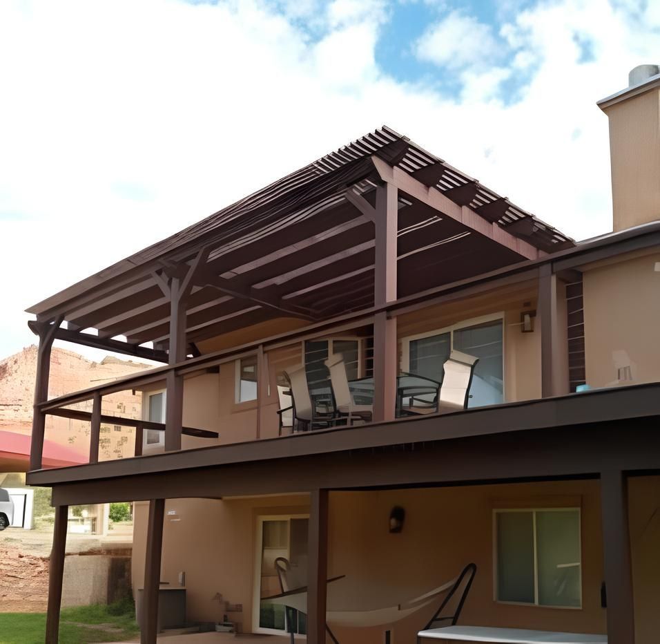 A house with a large deck with chairs on it