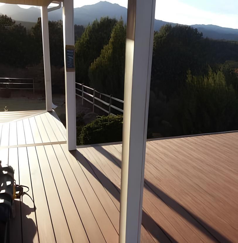 A wooden deck with mountains in the background
