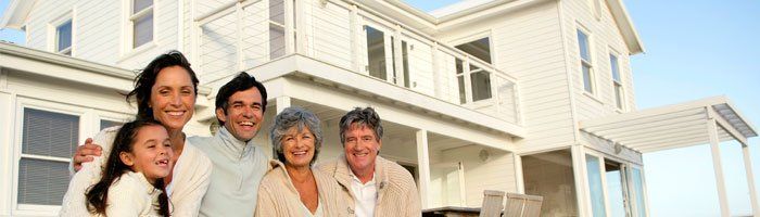 A family standing in front of a house