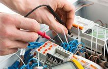 Electrician working on electric board