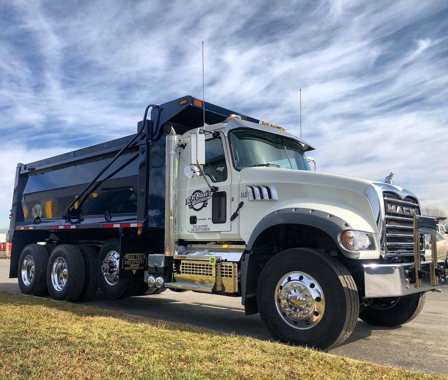 A dump truck is parked on the side of the road.