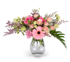 a vase filled with pink and purple flowers on a white background .