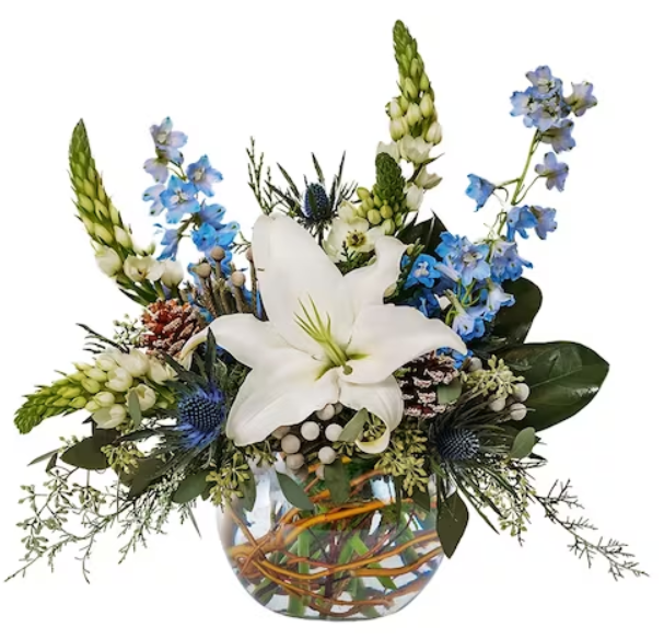 a vase filled with blue and white flowers on a white background