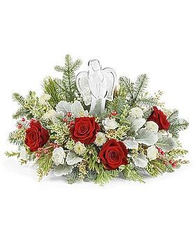 Floral arrangement with red roses, white flowers, and a glass angel.