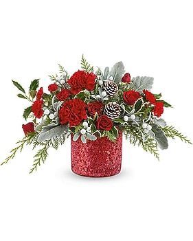 Red floral arrangement in a sparkly red vase with carnations, roses, pinecones, and greenery.
