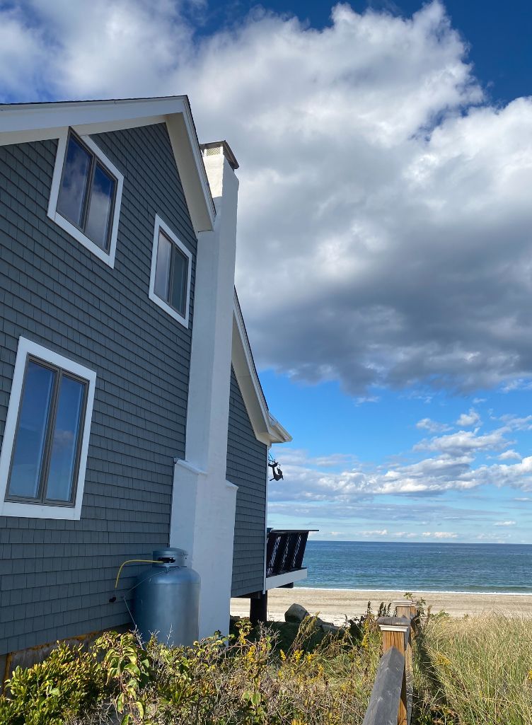 A house with a view of the ocean on a cloudy day