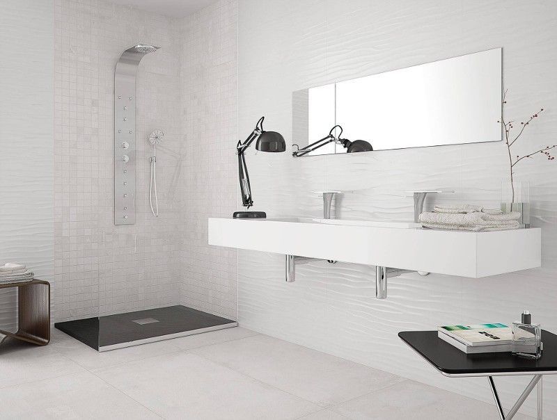 A bathroom with a sink , mirror and shower.