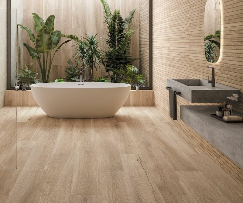 A bathroom with a bathtub , sink and mirror.