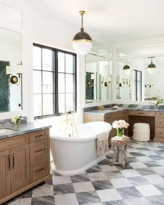 A bathroom with a bathtub and a checkered floor