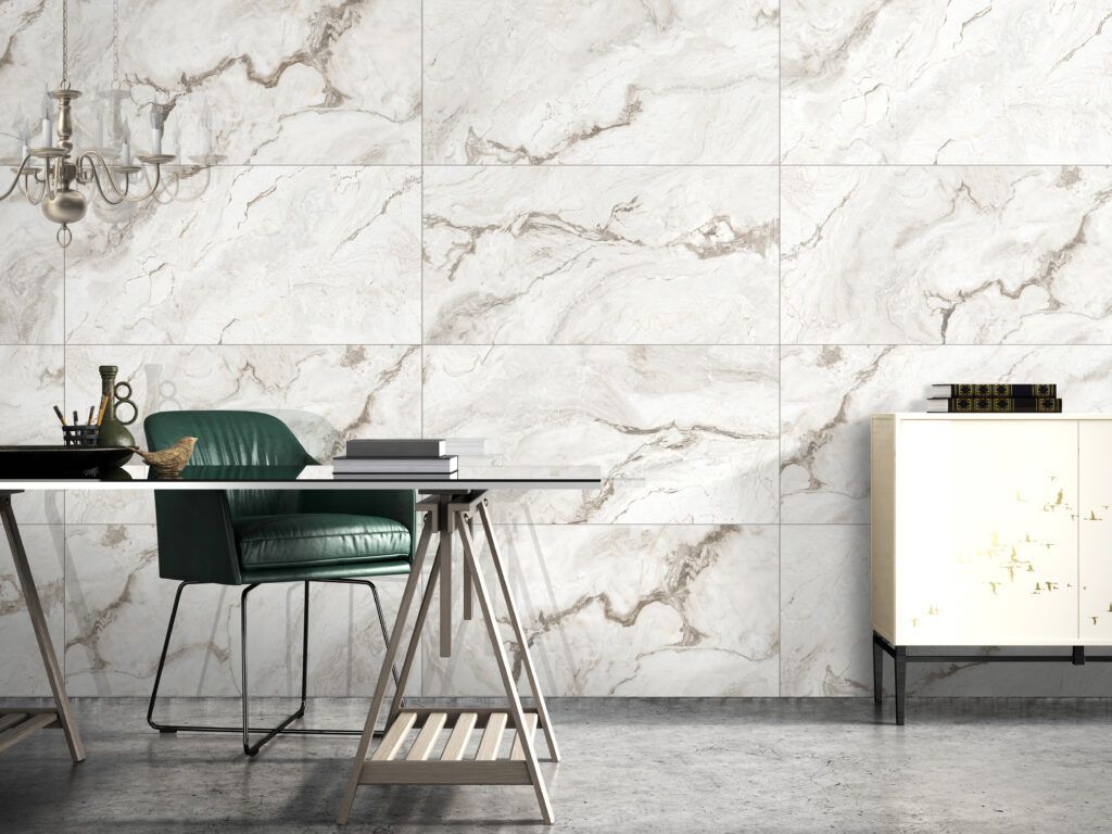 A desk with a chair in front of a marble wall.