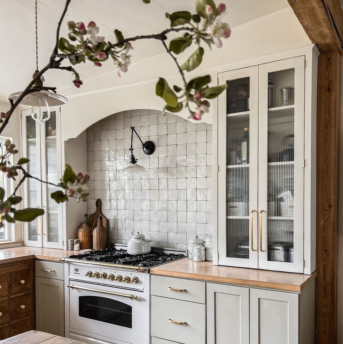A kitchen with white cabinets and a stove top oven