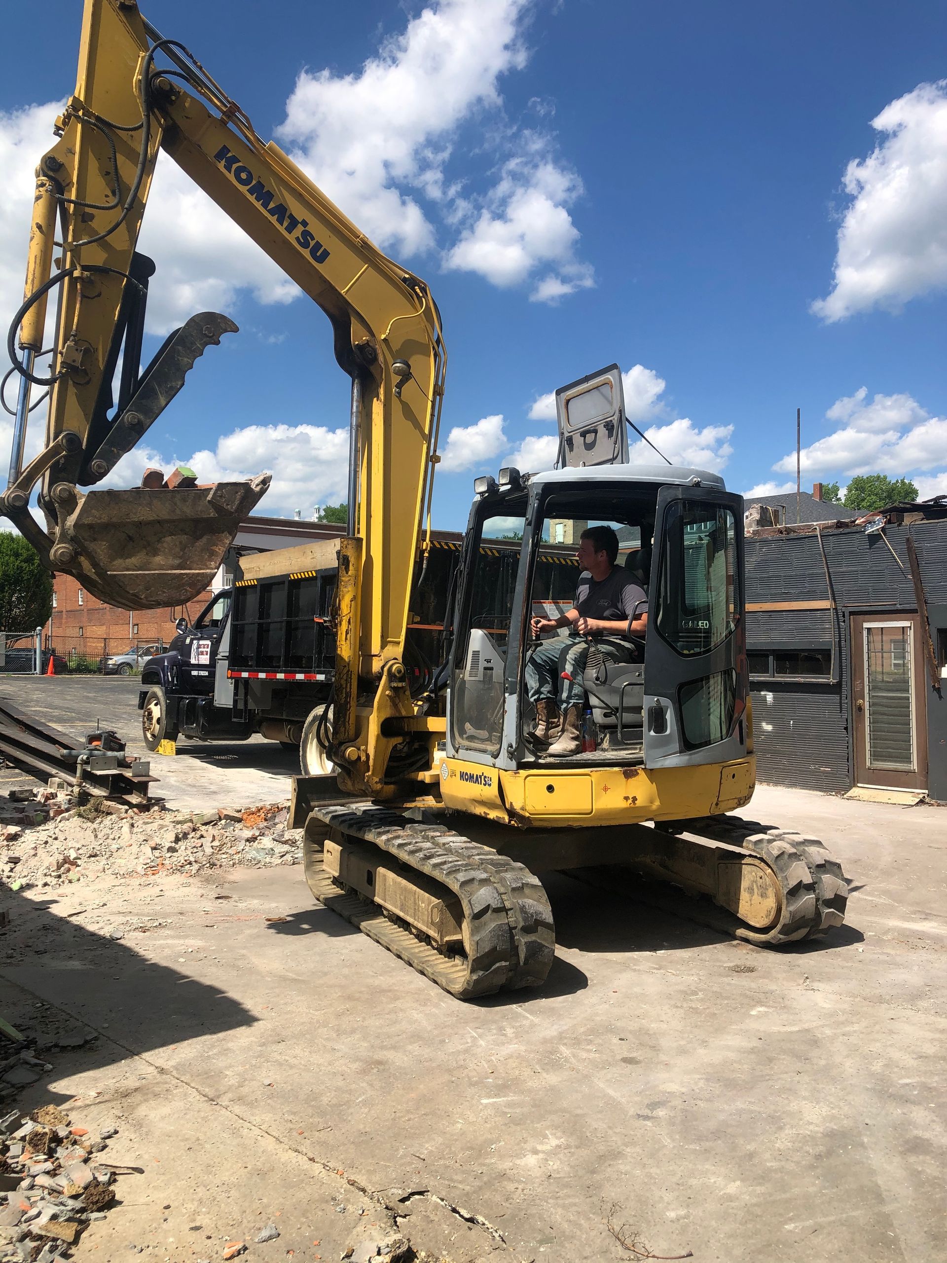 Yellow dump trucks and backhoes