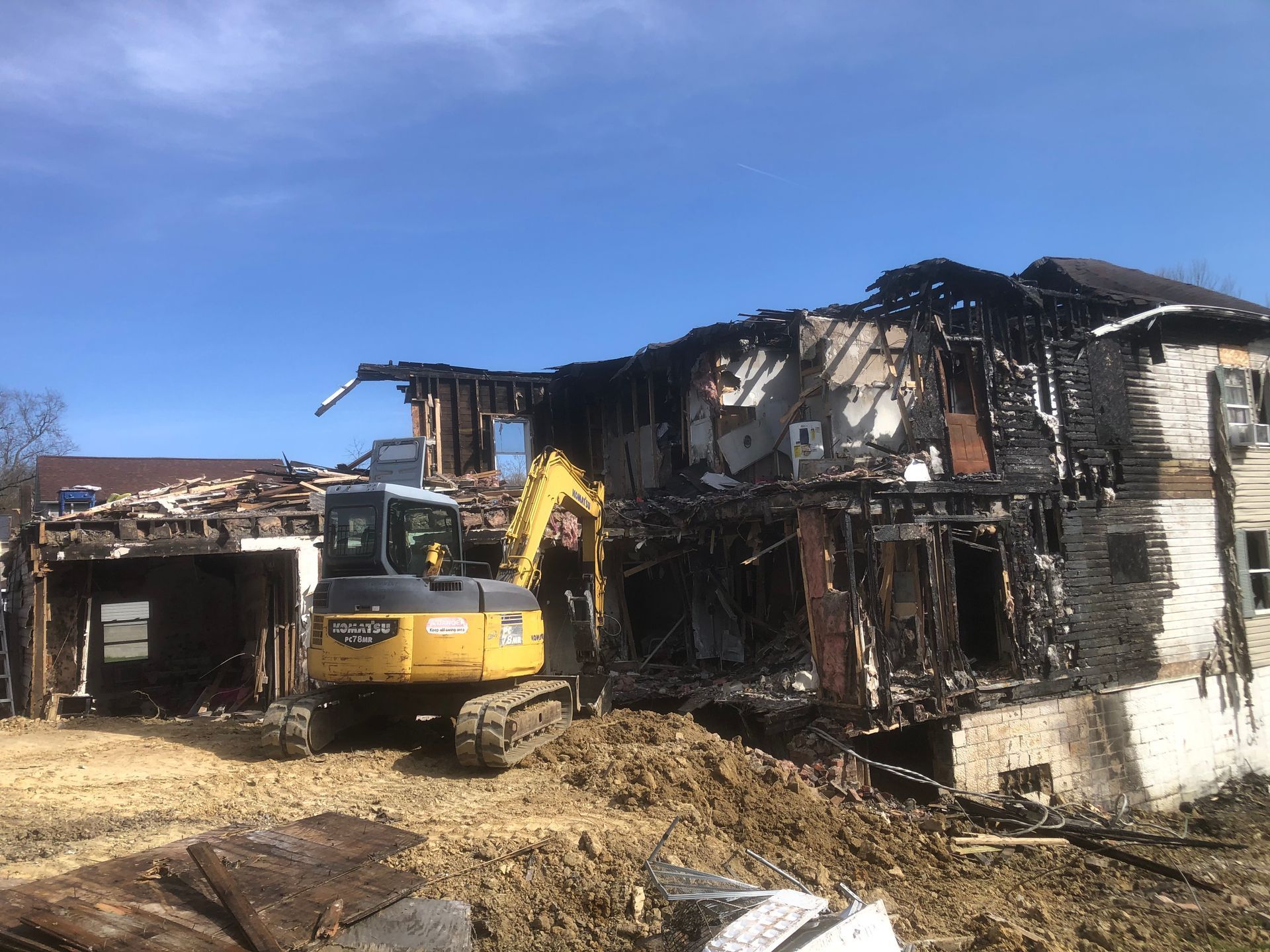 Demolishing a house with a backhoe