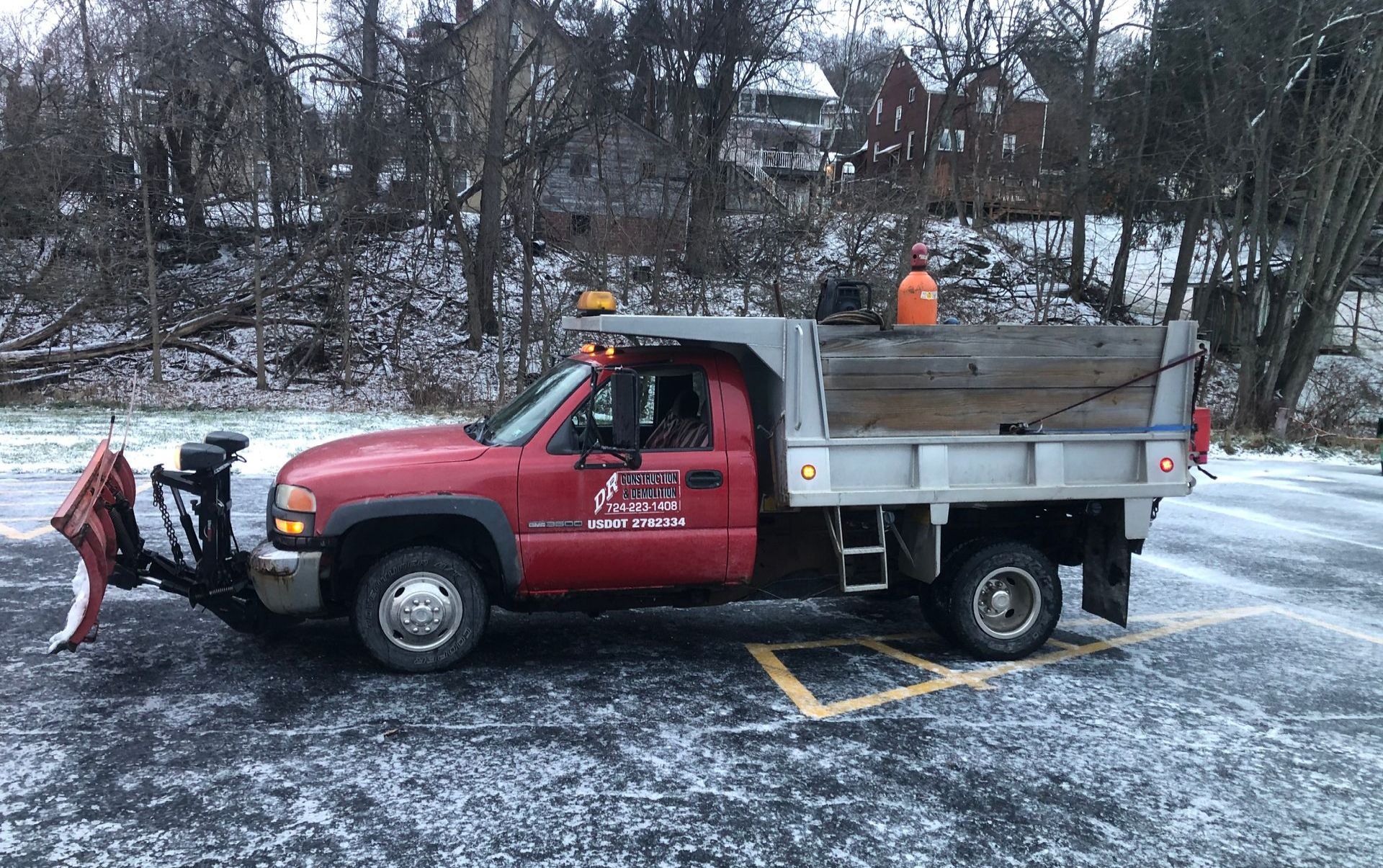 Removing snow by backhoe