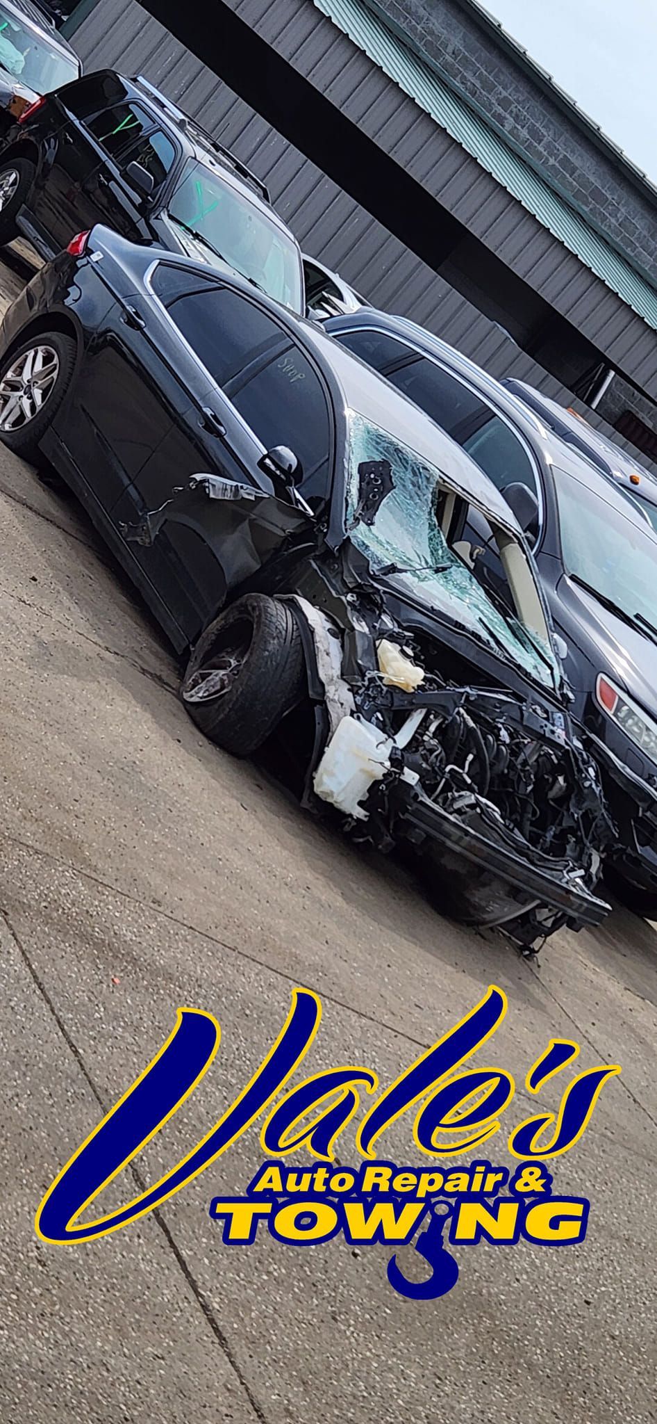 A severely damaged black car, Vale's Auto Repair & Towing logo at the bottom.