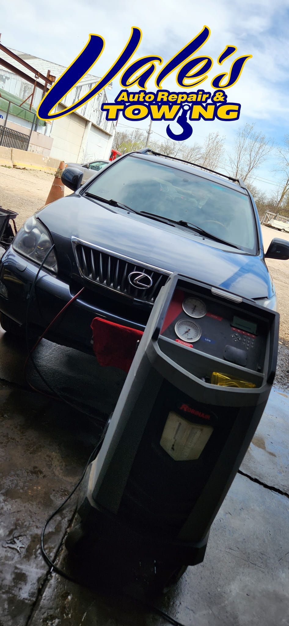 Black car being serviced at Vale's Towing. A diagnostic machine is in front of the car. The logo is in the top left.