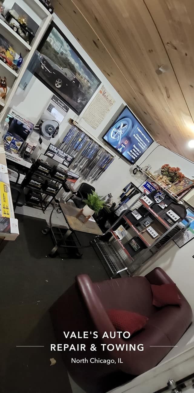 Interior shot of Vale's Auto Repair & Towing business. Shop includes a waiting area with a red couch, and service counter.