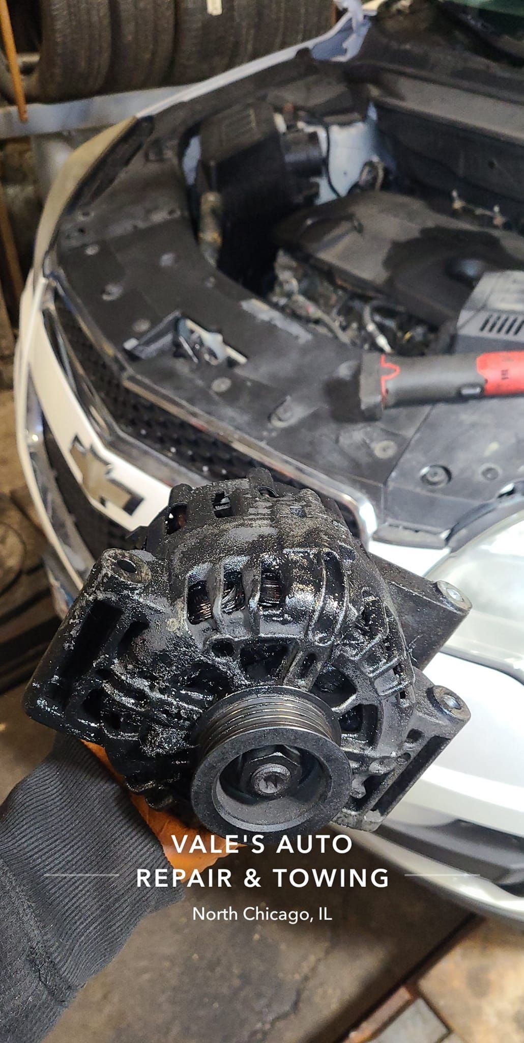 A car engine removed from a vehicle is shown at a car repair shop. 