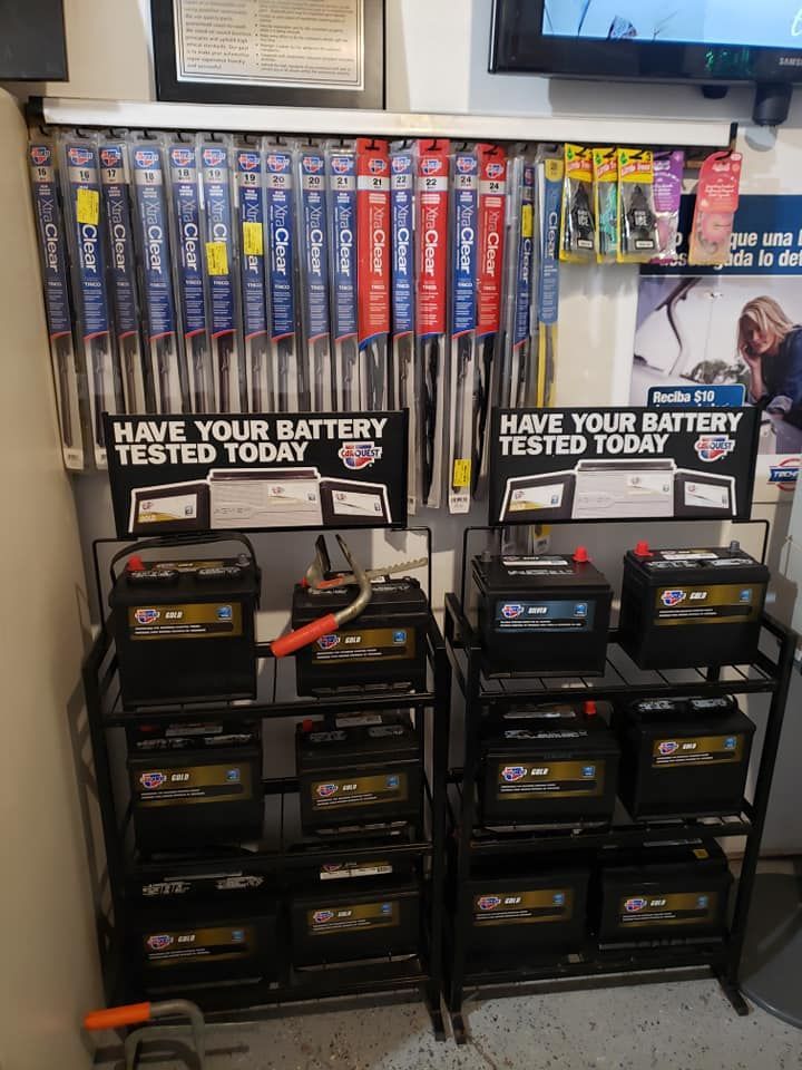 Car battery display in a shop, with wiper blades and 